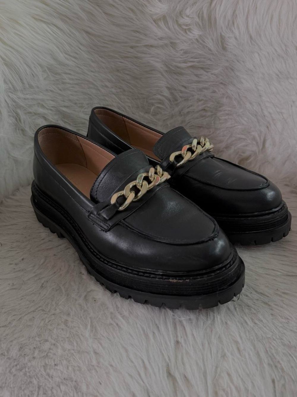 black leather loafers with gold chain detail